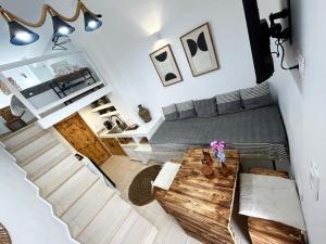 a bedroom with a bed and a wooden table at Babatseratsi skyrian studio 2 in Skiros