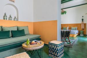 a living room with a couch and a table at Le Palazzo in Essaouira +37 photos