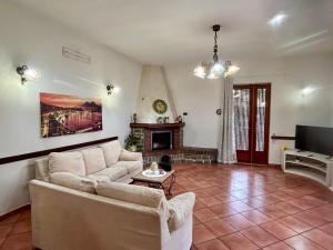 a living room with a couch and a fireplace at Maison Coppola in Vico Equense