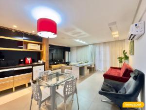 a living room with a glass table and a couch at Hotel na Beira Mar de Fortaleza in Fortaleza