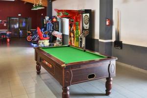 a pool table in a room with avertisement at Camping maeva Club L'Atlantique in Angles