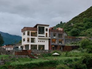 a house sitting on top of a hill at DAINN Mt Siguniang in Mount Siguniang