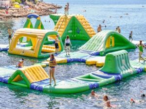 a group of inflatable slides in the water at a beach at Villa Nori Labin in Labin