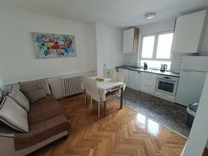 a living room with a couch and a table at Urban View - Main Square Gate Apartment in Skopje