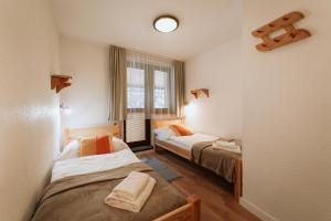 Ένα ή περισσότερα κρεβάτια σε δωμάτιο στο Horský hotel Bartoška