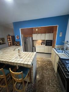 a kitchen with a large island in a room at Lower Price, More Style, Discount Studio In San Juan,Pr, Beach, Free Bikes in San Juan