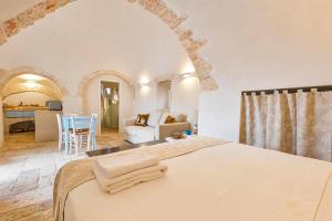 A bed or beds in a room at Masseria Macchia