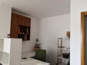 a room with a table and a green chair at Apartman17 in Sremska Mitrovica