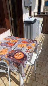 a table with a table cloth on top of it at Home Nala in Giardini Naxos +2 photos