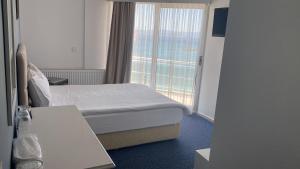 Postel nebo postele na pokoji v ubytování Pasifik Hotel