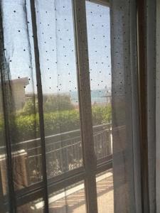 a view of a window with raindrops on the glass at La casa di Franca in Formia