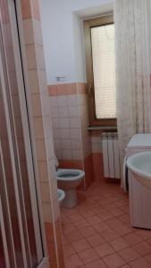 a bathroom with a toilet and a sink and a window at La casa di Franca in Formia +18 photos