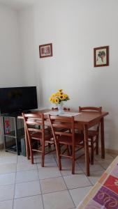 a dining room table and chairs with flowers on it at La casa di Franca in Formia +40 photos