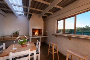 a dining room with a table and a fireplace at Fungamukaba Sanctuary in Mossel Bay +31 photos