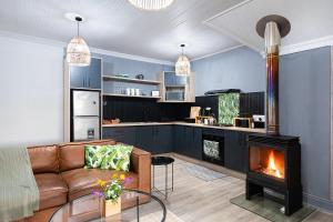 a living room with a couch and a fireplace at Fungamukaba Sanctuary in Mossel Bay
