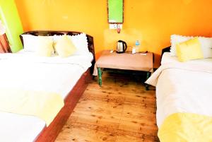 A bed or beds in a room at Hotel Butterfly - Peaceful Garden for Nature Lovers