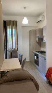 a kitchen with a table and a dining room at Home Apollo in Giardini Naxos