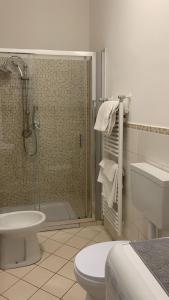 a bathroom with a shower and a toilet and a sink at Home Apollo in Giardini Naxos +6 photos
