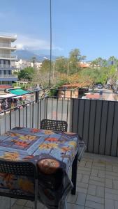 a table and chairs sitting on a balcony with a view at Home Apollo in Giardini Naxos