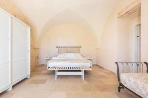 A bed or beds in a room at Masseria Macchia