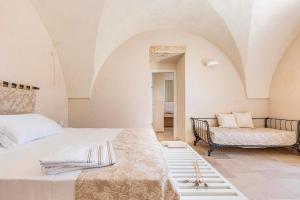 A bed or beds in a room at Masseria Macchia
