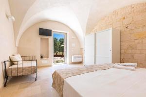 A bed or beds in a room at Masseria Macchia