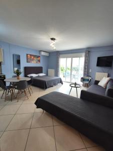 a living room with two beds and a table at Eretria Apartments FM14 in Eretria