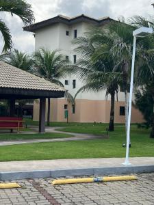 ein Gebäude mit Palmen in einem Park mit gelben Pfosten in der Unterkunft Vg Sun Cumbuco in Cumbuco