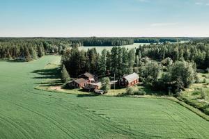 an aerial view of a farm with a house and a field at Elämysmajoitus Olipa Kerran in Turku