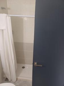 a bathroom with a shower curtain and a toilet at Hotel l'Albera in La Jonquera +5 photos