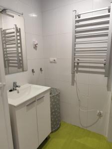 a white bathroom with a sink and a shower at El apartamento de Fina in Gijón