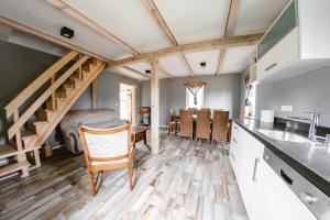 a kitchen and dining room with a wooden floor at Ostoja Poleska in Kołacze