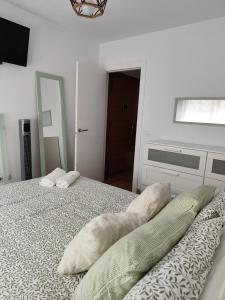 a bedroom with a bed with two pillows on it at El apartamento de Fina in Gijón