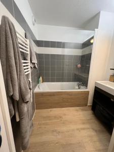 a bathroom with a tub and a sink at Les chalets du verdon in Allos +5 photos