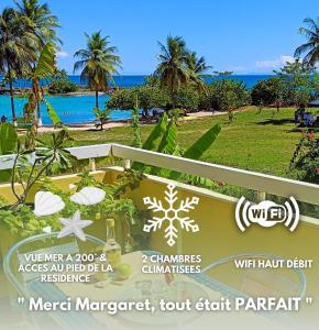 ein Schild für ein Resort mit Strandblick in der Unterkunft Chez Marguerite by MAGCAR in Le Gosier