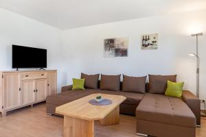 a living room with a couch and a table at Klabautermann in Heringsdorf