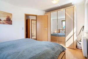 a bedroom with a bed and a large closet at Klabautermann in Heringsdorf
