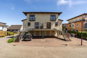 a large house with a staircase leading to a driveway at Klabautermann in Heringsdorf
