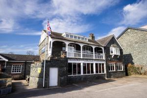 a large stone building with an american flag on it at Greta Howe in Keswick