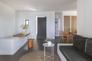 a living room with a couch and a table at Acron Villas Paros in Kolympithres