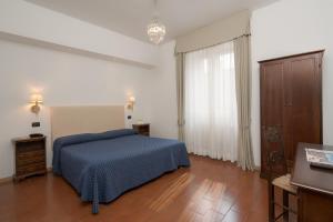 Postel nebo postele na pokoji v ubytování Hotel Titano