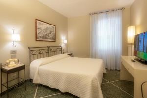 Postel nebo postele na pokoji v ubytování Hotel Titano