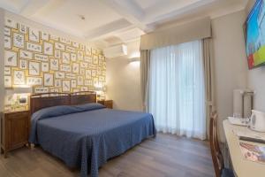 Postel nebo postele na pokoji v ubytování Hotel Titano
