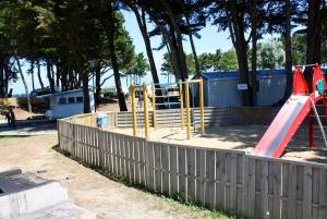 a park with a playground with a slide at La petite folie in Quiberon
