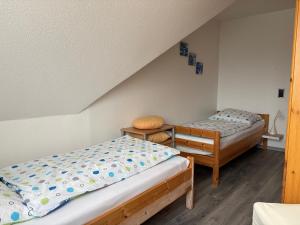 a bedroom with two beds and a staircase at Ferienwohnung Elina-Sophia in Geilenkirchen