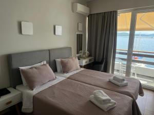 a bedroom with a bed with two towels on it at Hotel Avra in Preveza +45 photos