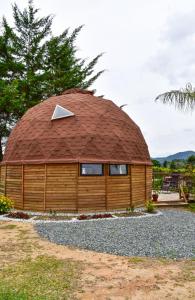 a large wooden building with a round roof at betsaida in Chiquinquirá +13 photos