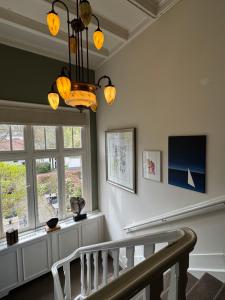 a room with a staircase and a chandelier at POSTEN nordic cuisine in Frederiksoord