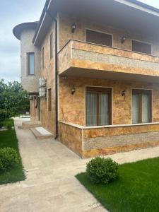 a brick house with a pathway in front of it at premium park apart otel in Kemer