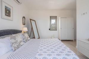 a white bedroom with a bed and a window at Tranquil house in Kipséli +52 photos